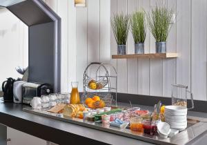 a tray of food on a counter in a kitchen at Hotel Restaurant L'Atlantique in Saint-Jean-de-Monts +19 photos