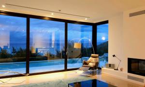 a living room with a view of a swimming pool at PRIVE The Luxury Villa & Boutique Hotel, Cape of Rodon in Draç