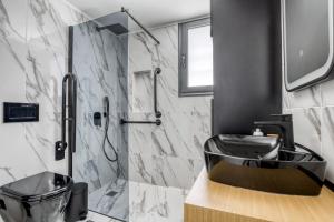 łazienka z umywalką i prysznicem w obiekcie Spacious flat with courtyard in Peristeri! w Atenach +41 zdjęć