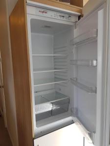 an empty refrigerator with its door open in a kitchen at Waterside Holiday Park Paignton Sleep 6 caravan in Paignton
