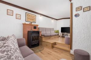 a living room with a couch and a fireplace at House Obrš in Mošćenička Draga