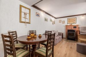 a living room with a table and chairs and a couch at House Obrš in Mošćenička Draga