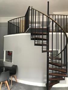 a spiral staircase in a house with a table and chairs at Leevin Studios in Dublin