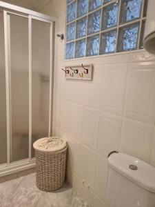 a bathroom with a shower and a toilet and a window at COSTA DAURADA APARTAMENTS - 174 Formentor Luxe II in Salou