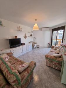 a living room with two couches and a flat screen tv at COSTA DAURADA APARTAMENTS - 174 Formentor Luxe II in Salou