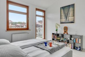 a bedroom with a bed and a book shelf at Grand Apartments - Neptun Park Escala Seaside Apartment in Gdańsk