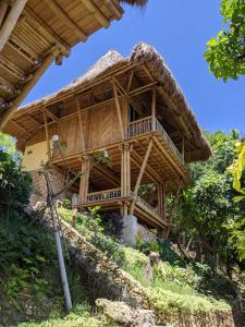 a large bamboo house with a thatched roof at Elang Hillside Bamboo Villas in Labuan Bajo