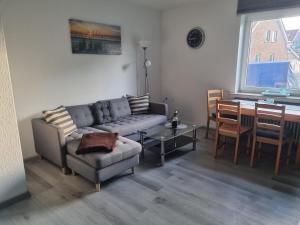 a living room with a couch and a table at Fewo Minsen in Wangerland