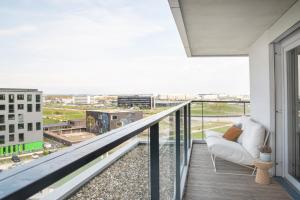 a balcony with a couch and a view of a city at ipartment Böblingen Region Stuttgart in Böblingen