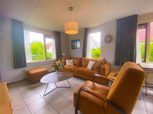 a living room with a couch and a table at Hello Zeeland - Vakantiehuis Stern 233 in Breskens
