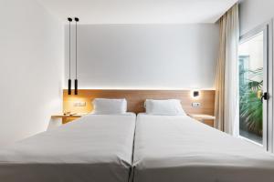 מיטה או מיטות בחדר ב-Hotel Areca