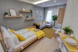 a bedroom with a large bed with yellow pillows at RP1 Apartment in Budapest