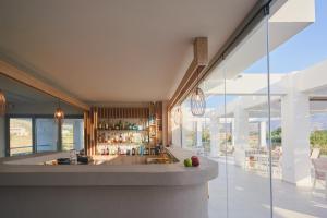 a kitchen with a counter and a bar at Sunny View Hotel in Kardamaina