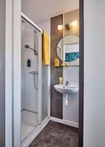 a bathroom with a shower and a sink at Hotel Restaurant L'Atlantique in Saint-Jean-de-Monts