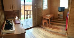 a kitchen with a stove and a table in a room at Kazikówka - Domki letniskowe w Solinie in Solina