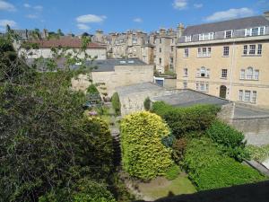 
a large green garden with a large clock tower at 18 The Circus Apartment in Bath
