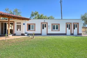 a rendering of a house with a yard at Apartments & Bungalows Ivanović in Kaštela