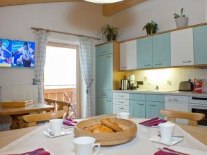 a kitchen with a table with a bowl of bread at Holiday Home Haus Seitner - BMG160 by Interhome in Mühlbach