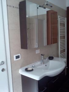 a bathroom with a white sink and a mirror at B&B Trento Nord in Trento