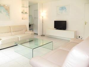 a living room with a couch and a glass coffee table at Holiday Home La Marinière by Interhome in Trégunc