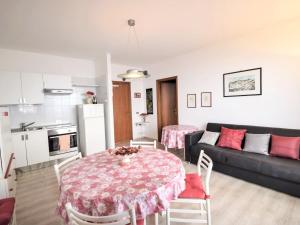 a living room with a table and a couch at Apartment Ikebana by Interhome in Taormina