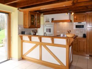 a kitchen with a wooden barn door in a room at Holiday Home Entre Terre et Mer - PML102 by Interhome in Ploumilliau