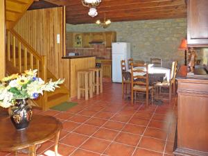a kitchen and living room with a table and chairs at Holiday Home La Ferme Bis by Interhome in Loctudy