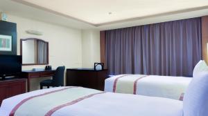 Postel nebo postele na pokoji v ubytování Zhong Ke Hotel