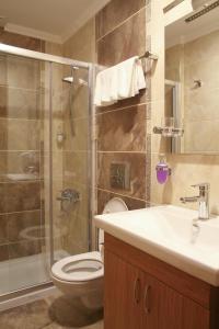 a bathroom with a shower and a toilet and a sink at Besiktas Otel in Istanbul