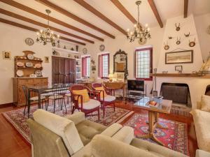 a living room with a table and a dining room at Holiday Home De la Cruz by Interhome in Aledo