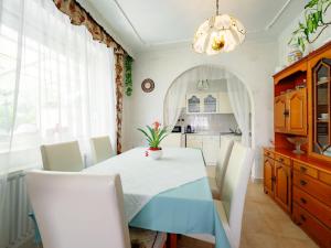 a dining room with a blue table and white chairs at Apartment Casablanca 1 by Interhome in Balatonszemes