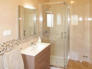a bathroom with a sink and a shower at Holiday Home Do Pinheiros by Interhome in Vau +14 photos