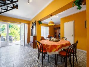 a dining room with yellow walls and a table and chairs at Holiday Home Verde by Interhome in Balatonlelle