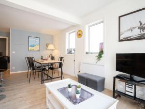 a living room with a table and a tv at Apartment Victoria by Interhome in Biarritz