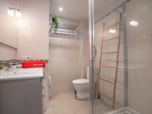 a bathroom with a shower and a toilet and a sink at Apartment Victoria by Interhome in Biarritz