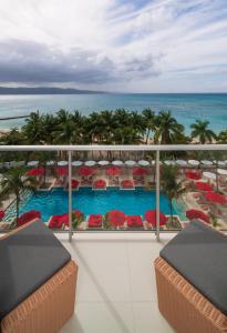 vistas a la piscina desde el balcón de un complejo en S Hotel Montego Bay - Luxury Boutique All-Inclusive Hotel, en Montego Bay