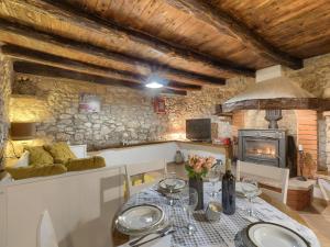 a dining room with a table and a fireplace at Holiday Home Susanne by Interhome in Gorica