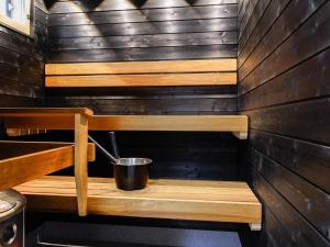 a sauna with a bucket on a wooden shelf at Holiday Home Meri-villa by Interhome in Kiviniemi