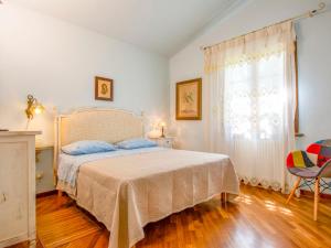A bed or beds in a room at Holiday Home Villa Rosa by Interhome