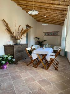 a patio with a table and chairs and a couch at B&B Su Strintu in Tuili