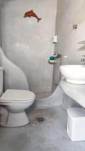 a bathroom with a toilet and a sink at kamares kythnos in Kanala