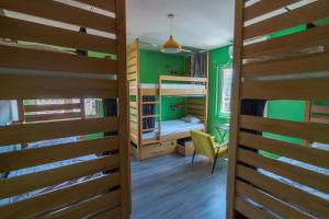 a bedroom with green walls and bunk beds at Old Town Hostel Ohrid in Ohrid