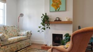 a living room with a couch and a fireplace at Argyll House Bed and Breakfast in Westleton