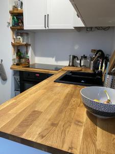 a kitchen counter with a bowl on a wooden counter top at Aparatament Śródmieście in Gdańsk