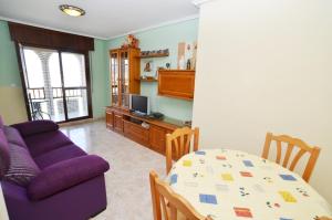 a living room with a purple couch and a table at Residencial Cilla - 6022 in Noja