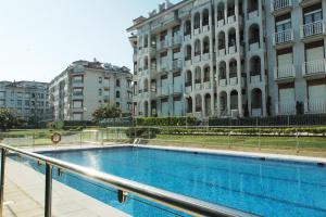 a large swimming pool in front of a building at Residencial Cilla - 6022 in Noja