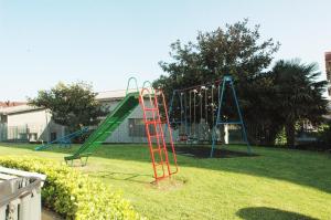 a playground with a slide in a yard at Residencial Cilla - 6022 in Noja