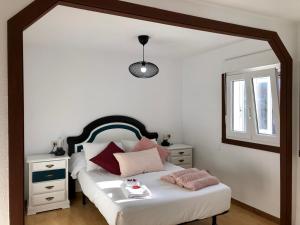 a bedroom with a bed with a mirror on it at El Nidito de Lara in Santiago de Compostela