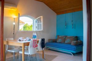 a living room with a table and a blue couch at VIScovery apartments in Vis +88 photos