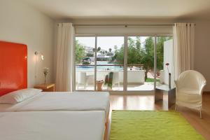 a bedroom with a bed and a view of a pool at Marina Club Lagos Resort in Lagos